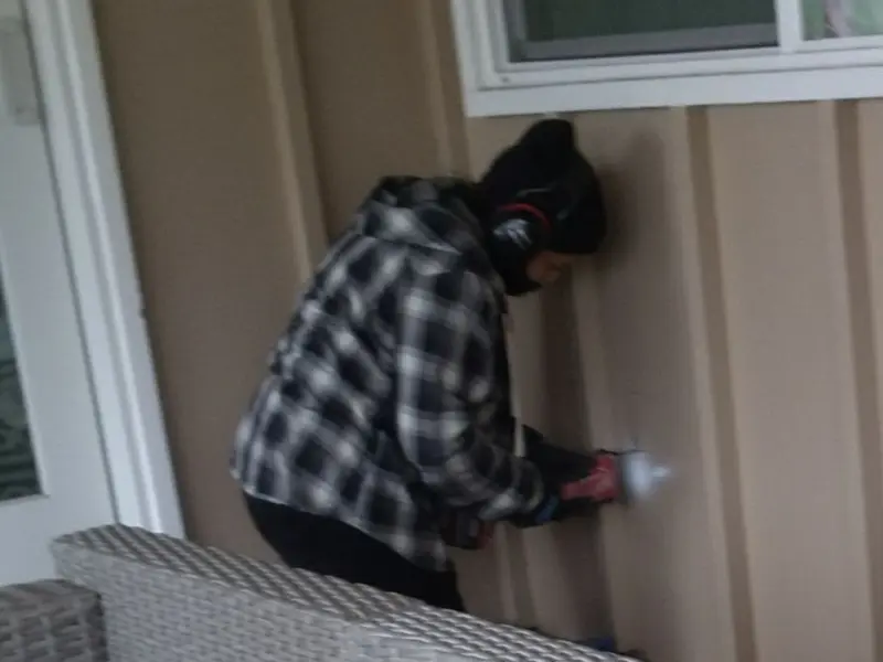 Professional electrician installing an exterior outlet in Coeur d'Alene